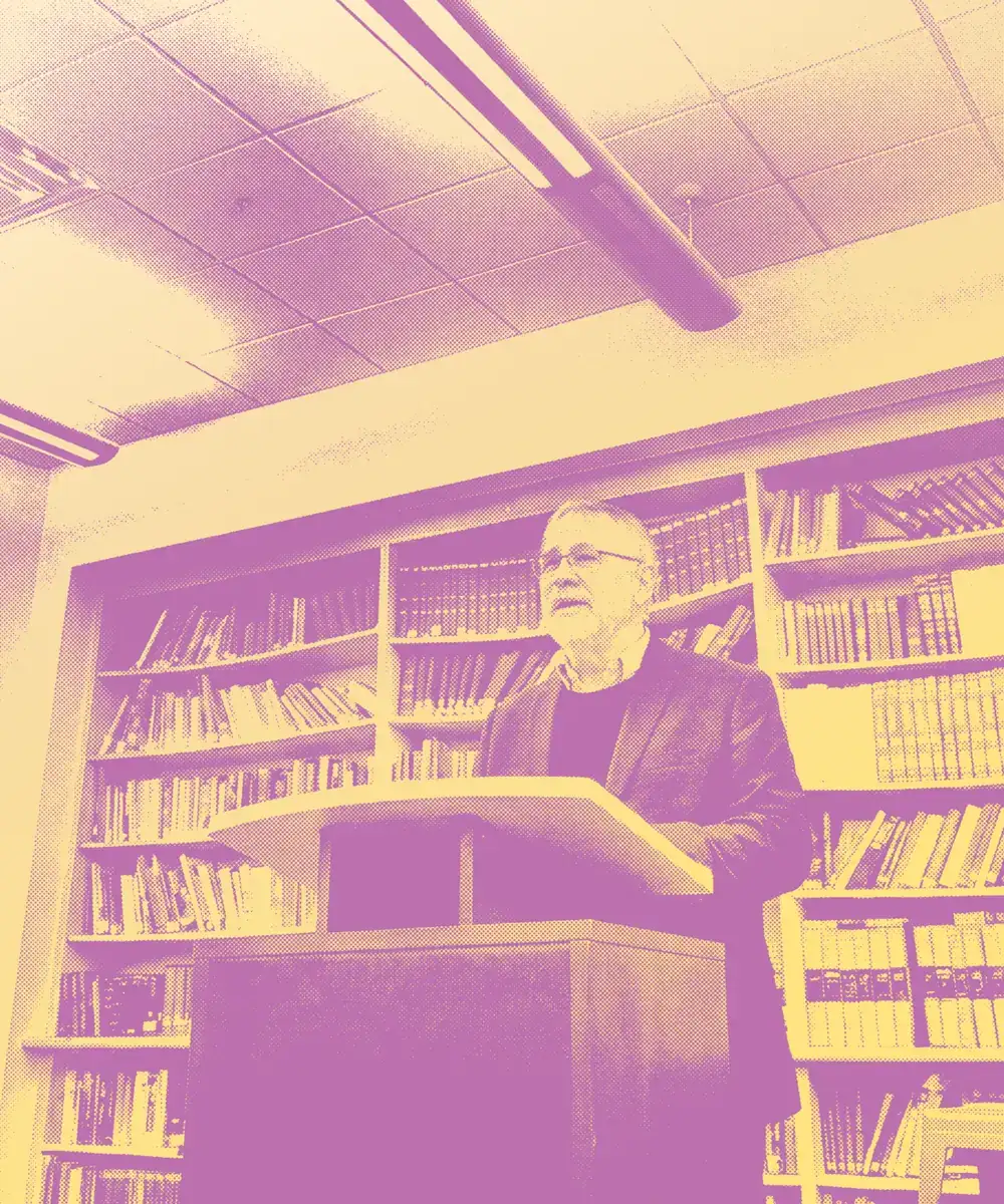 Rabbi Steven Greenberg speaking at a lectern in a library