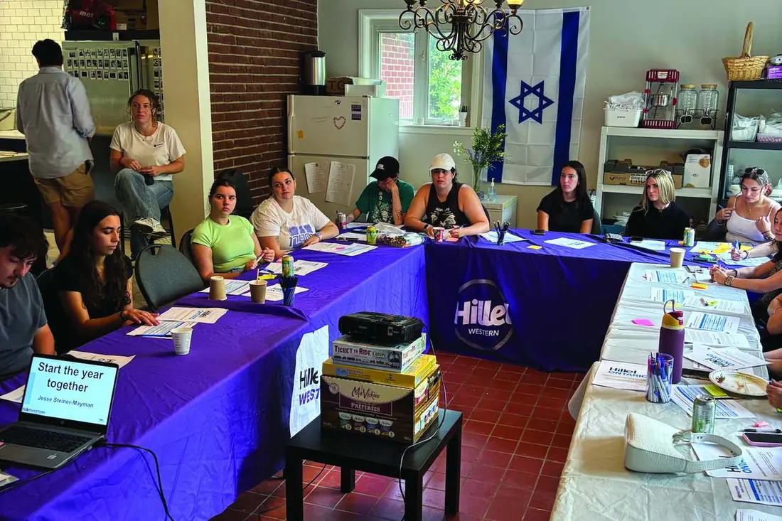 Students in a learning session around a Hillel table