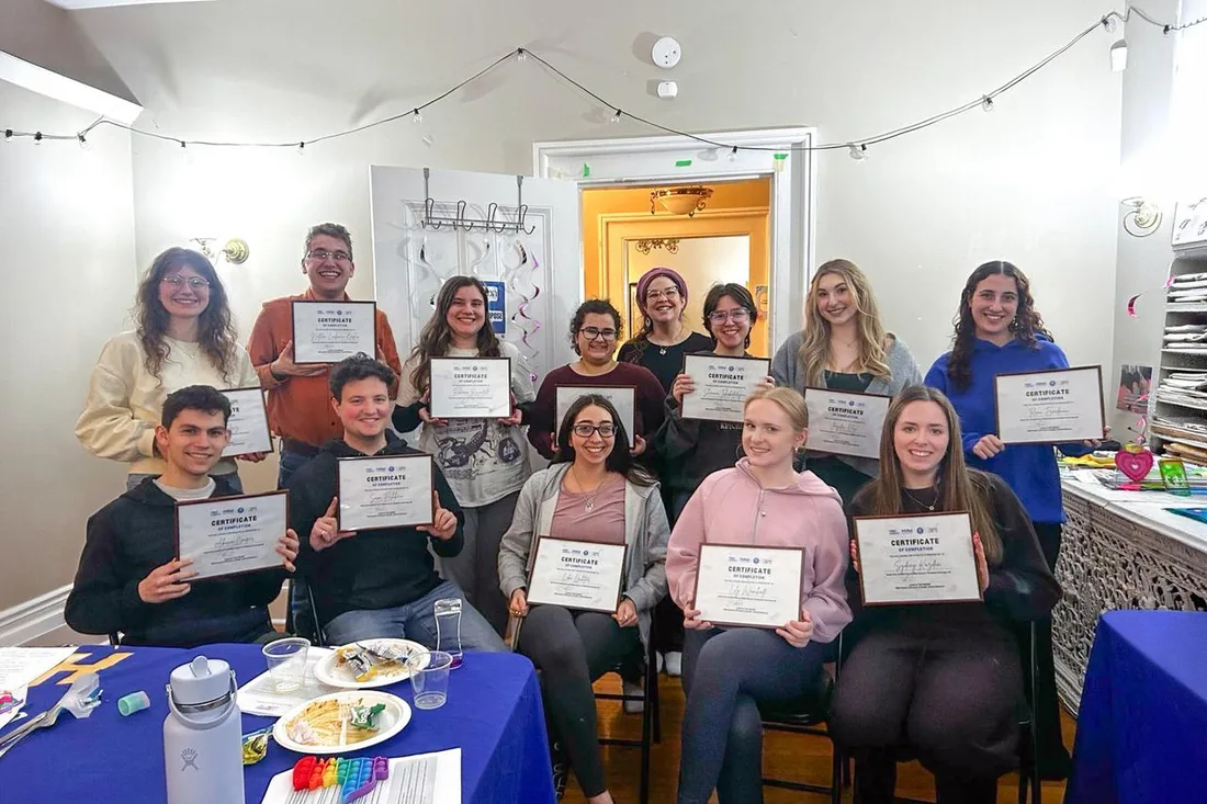 Kol Yisrael cohort students holding completion certificates