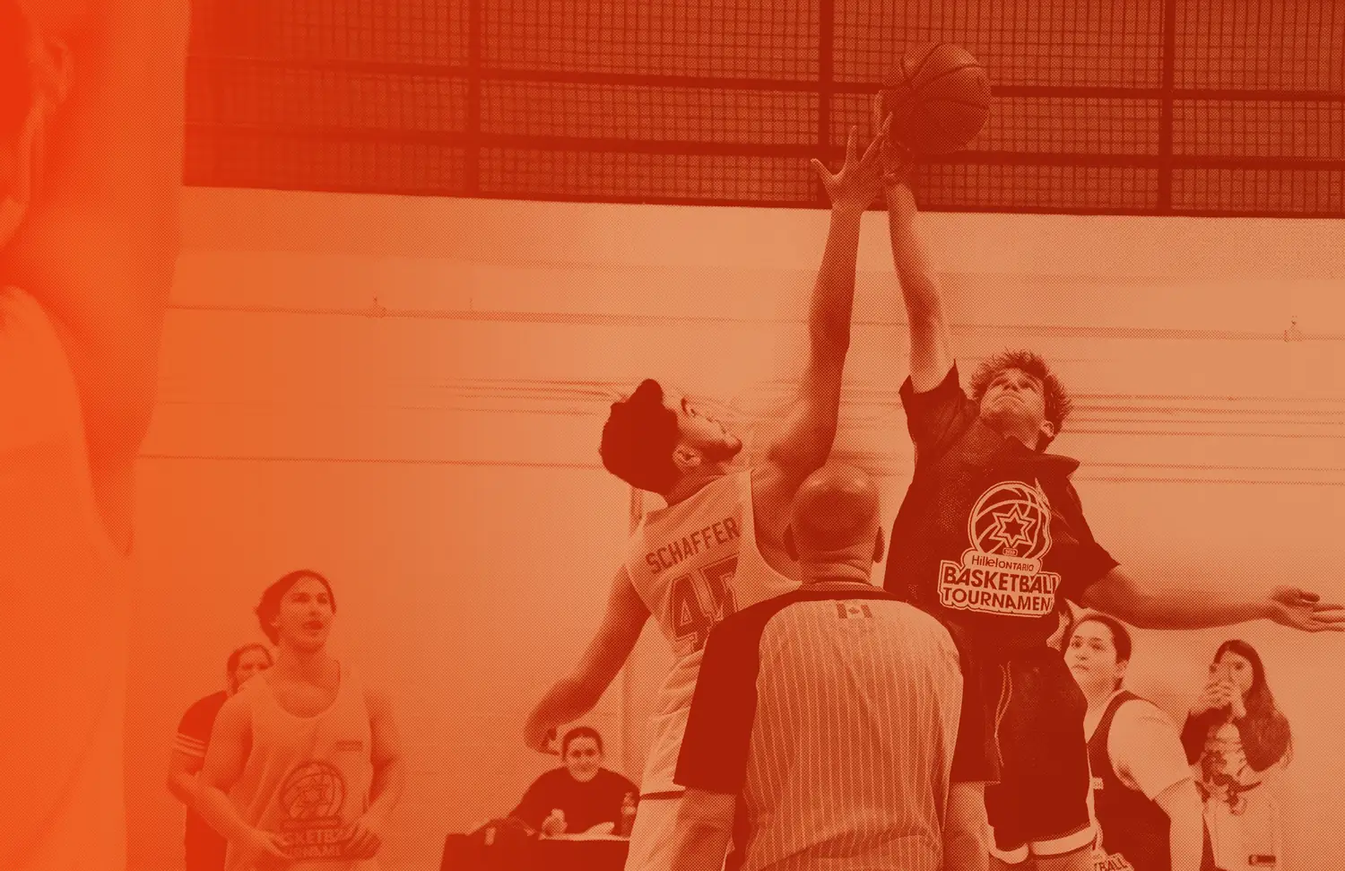 Two students leap for the opening tip-off at Hillel Ontario's Basketball Tournament