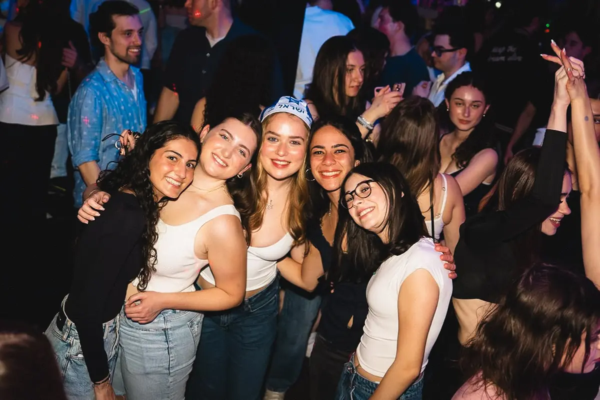 Students celebrating together at a Jewish holiday club night in Toronto