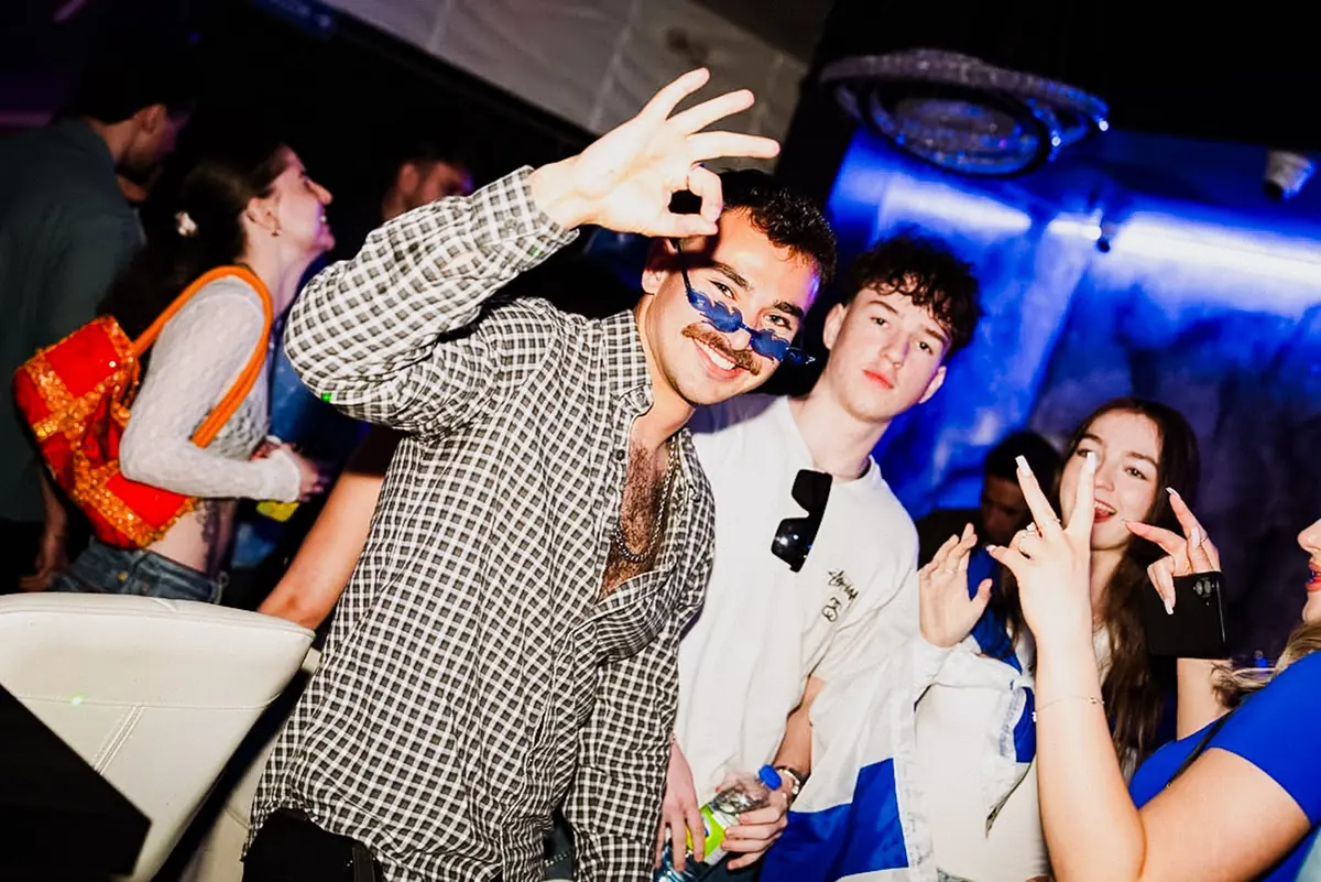 A packed dance floor lit up at a Hillel holiday club night