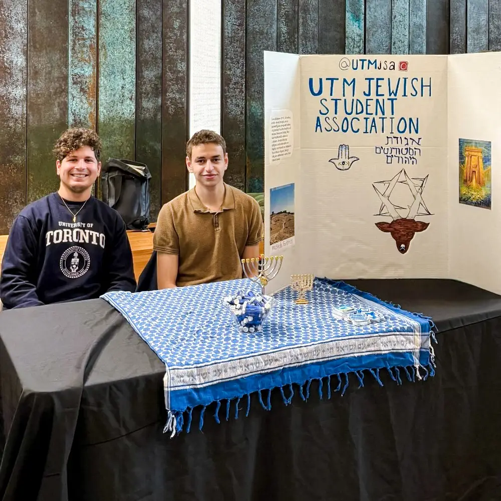 The UTM Jewish Student Association table with a handmade banner
