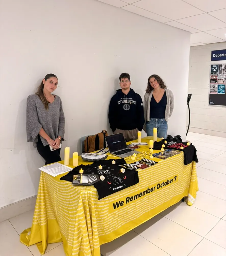 Students at a We Remember October 7 table on an emerging campus