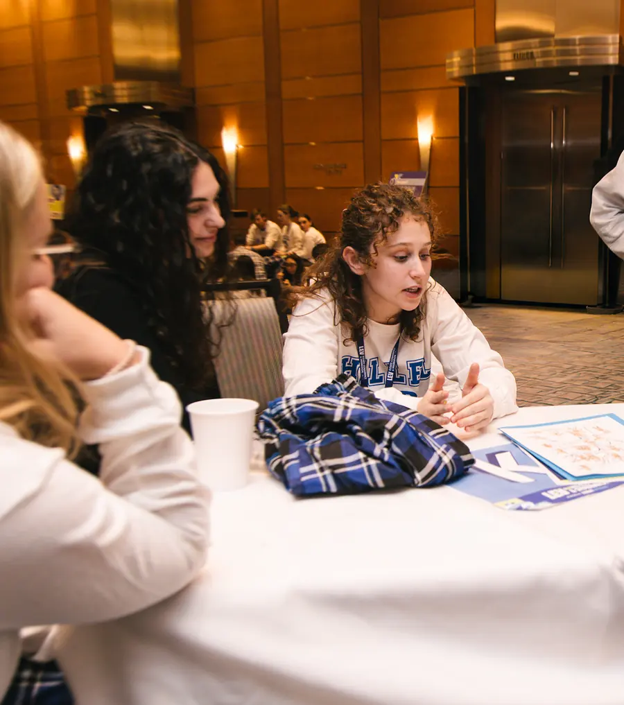 Students in conversation around a table at an emerging-campuses gathering