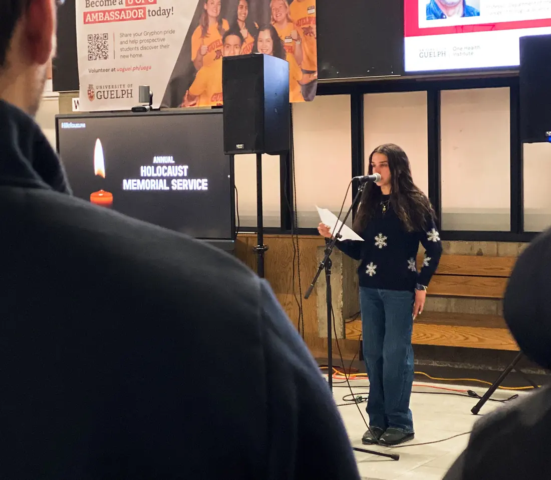 A student speaks at a campus Holocaust Memorial Service