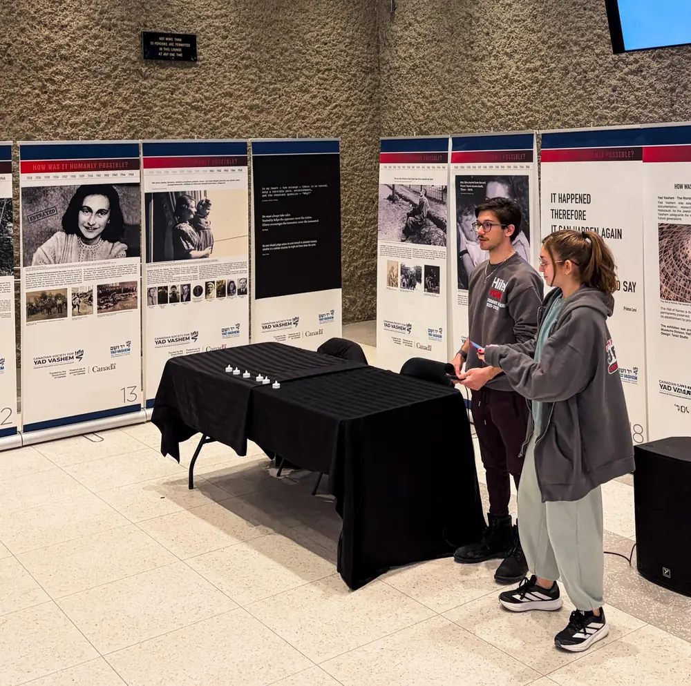 Students take in the Yad Vashem exhibit panels during Holocaust Education Week at York