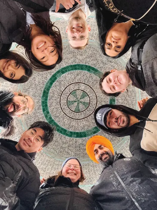 The Impressions cohort photographed from above in a circle