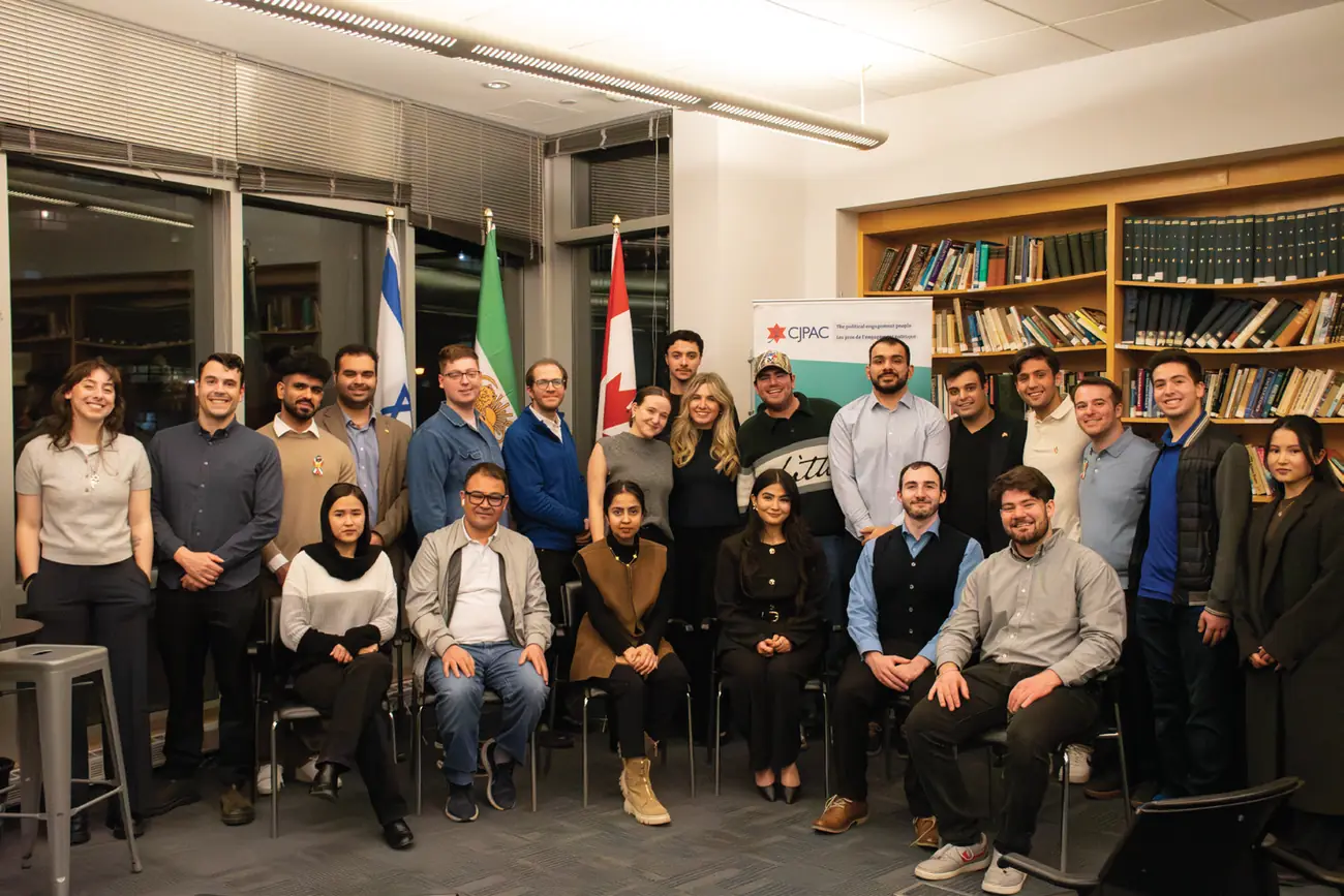 The fireside chat group in front of Israeli, Iranian, and Canadian flags